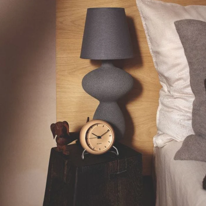 The City Hall Alarm Clock from Arne Jacobsen Clocks in a bedroom.