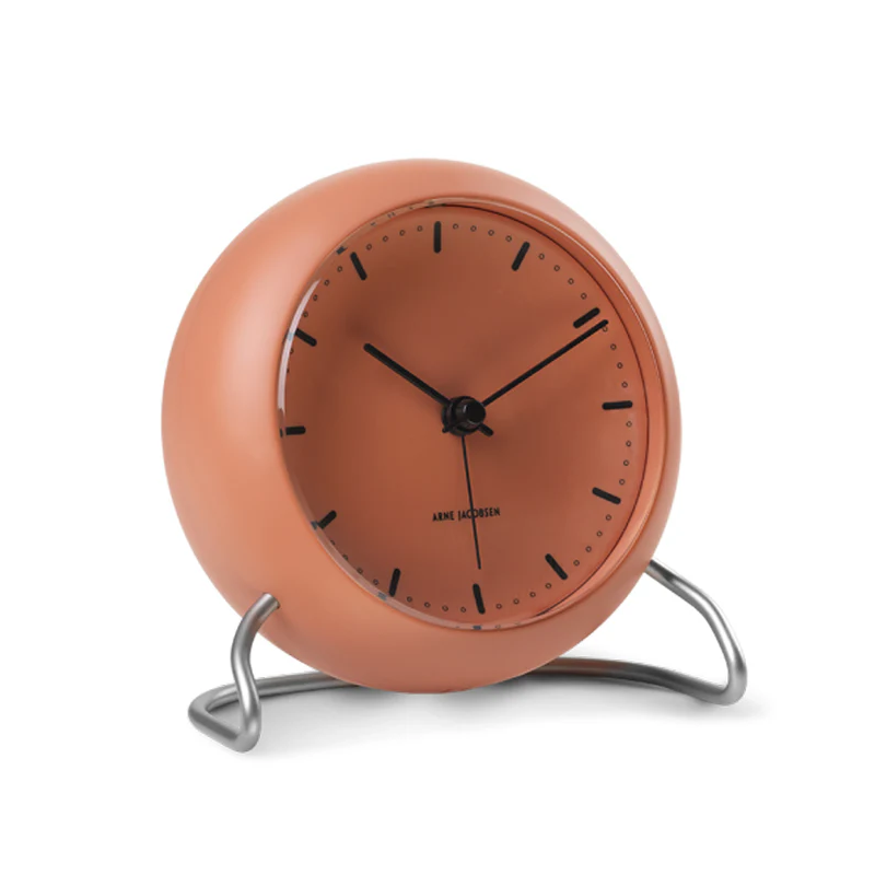 The City Hall Alarm Clock from Arne Jacobsen Clocks in pale orange from the side.