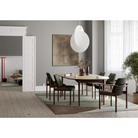 The Extendable Oma Dining Table from Eikund of Norway in a living room.