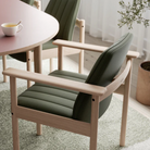 The Ry Armchair from Eikund of Norway in a dining room.