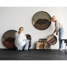 The Layered Dots Glass Tray from Ethnicraft with people for scale.