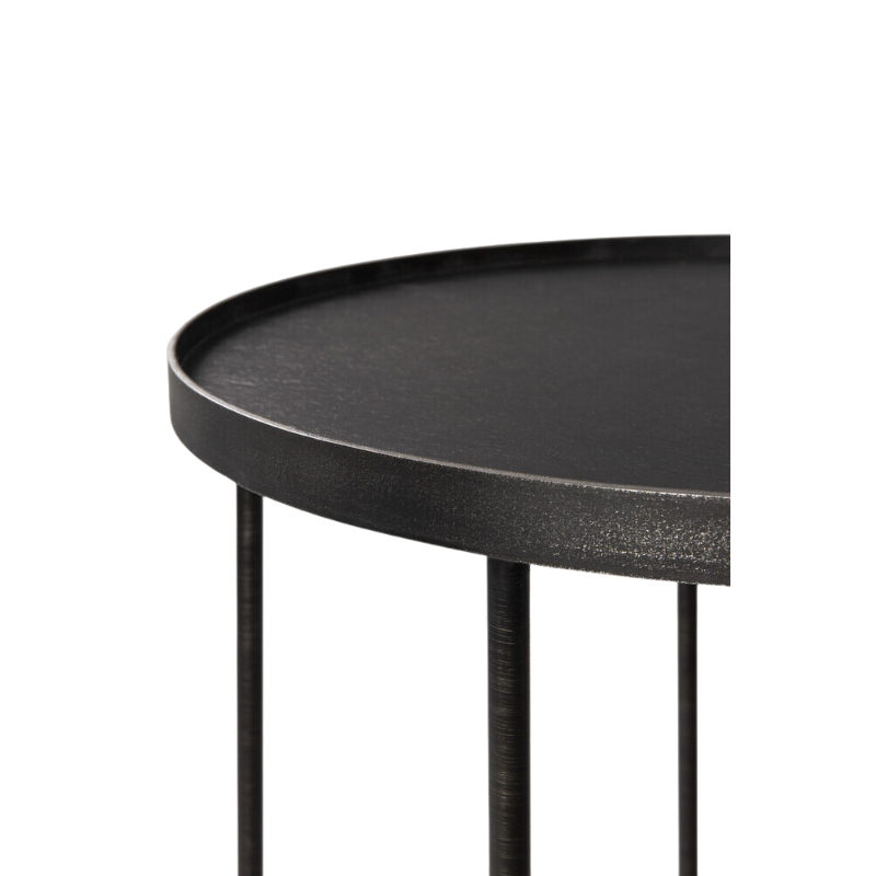 The round Tray Side Table from Ethnicraft in a studio.