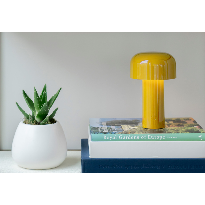 The Bellhop Portable Table Lamp from FLOS in an office.