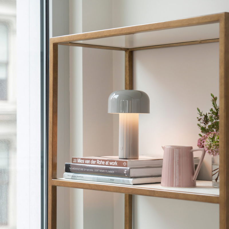 The Bellhop Portable Table Lamp from FLOS in a study.