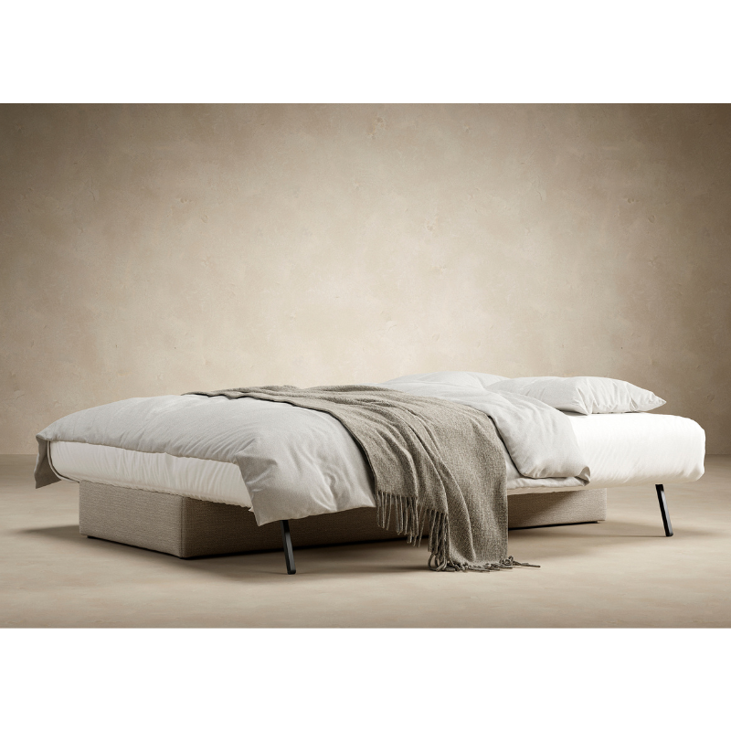 The Osvald Sofa Bed from Innovation Living set up with blankets as a bed.