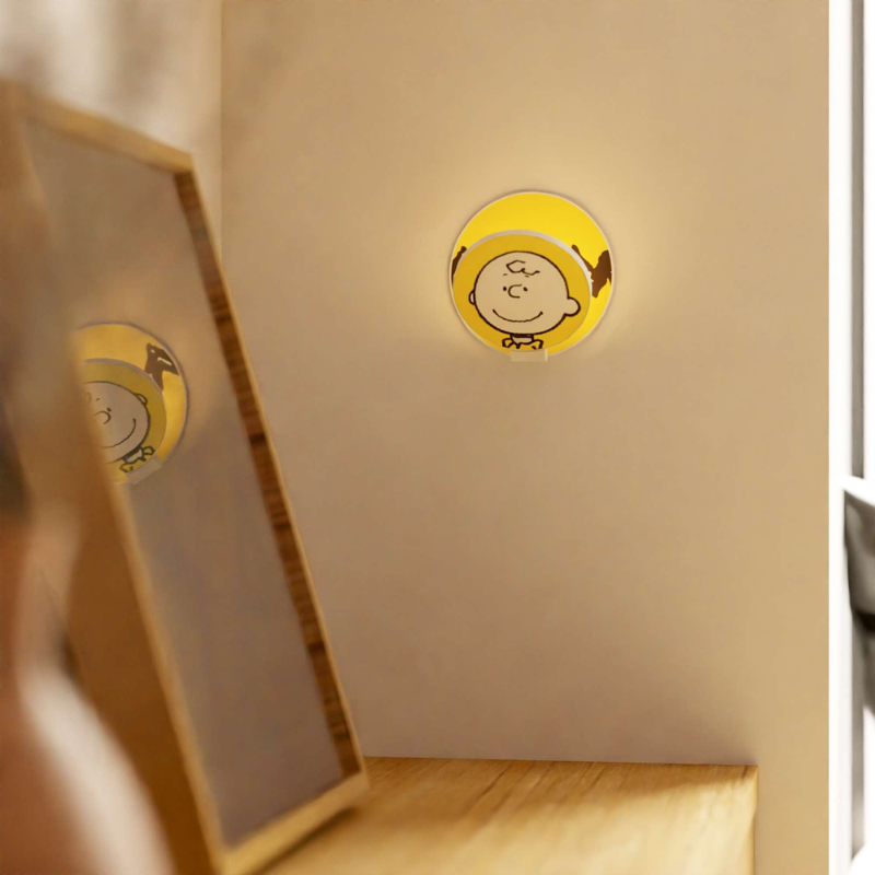 The Peanuts Edition Gravy Wall Sconce  from Koncept in the Charlie Brown style in an office.