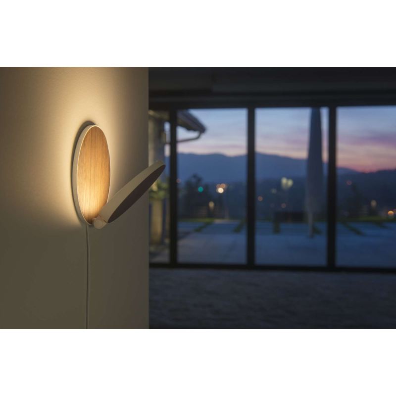 The Plug-In Gravy Wall Sconce from Koncept in a living room.