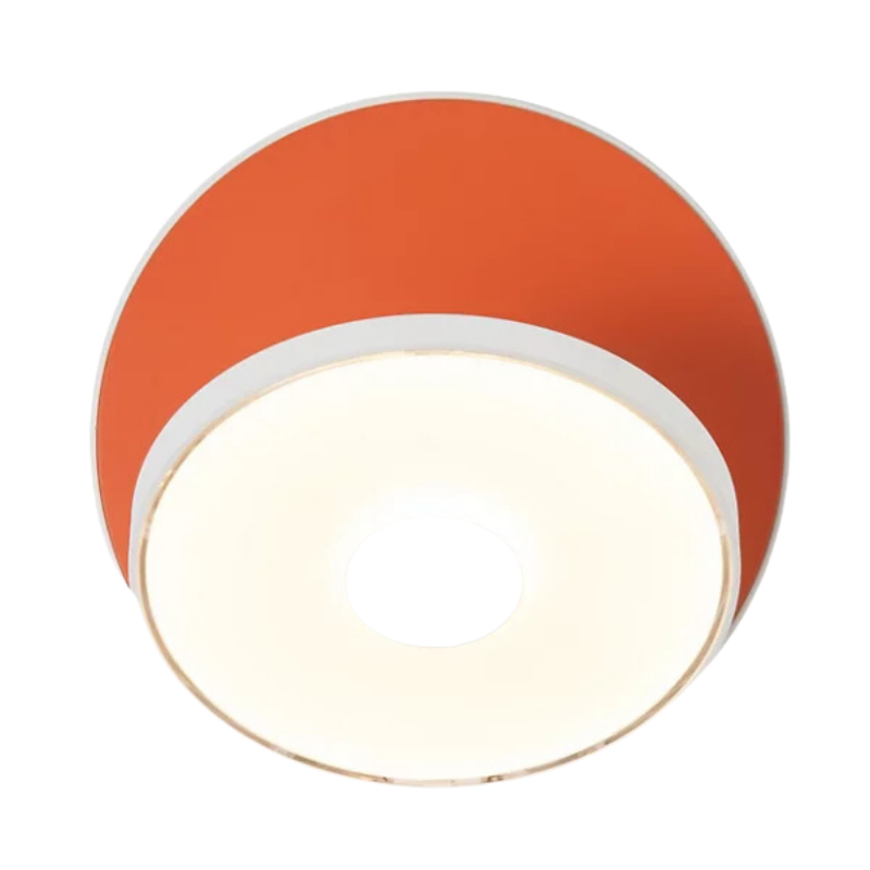 The Plug-In Gravy Wall Sconce from Koncept with the matte white body and matte orange plate.