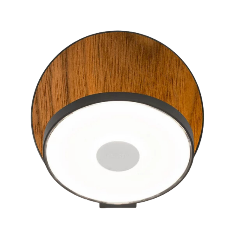 The Plug-In Gravy Wall Sconce from Koncept with the metallic black body and oiled walnut plate.