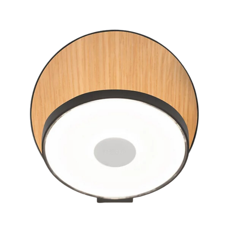 The Plug-In Gravy Wall Sconce from Koncept with the metallic black body and white oak plate.