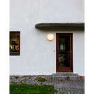 The AJ Eklipta Outdoor from Louis Poulsen, used as an outdoor wall sconce.