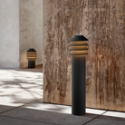 The short Bysted Garden Bollard from Louis Poulsen in an outdoor living shot.