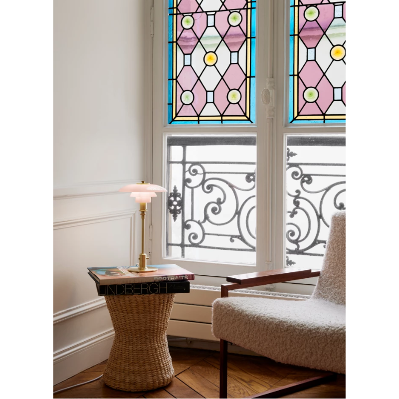 The PH 2/1 Pale Rose Brass Table Lamp from Louis Poulsen in a bedroom.