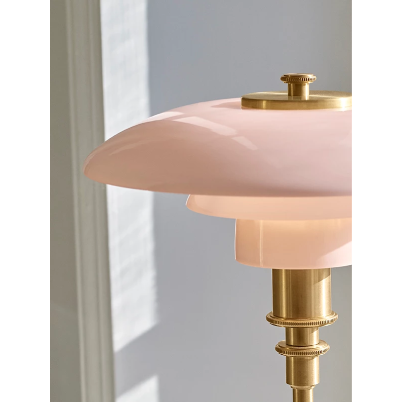 The PH 2/1 Pale Rose Brass Table Lamp from Louis Poulsen in a close up shot.