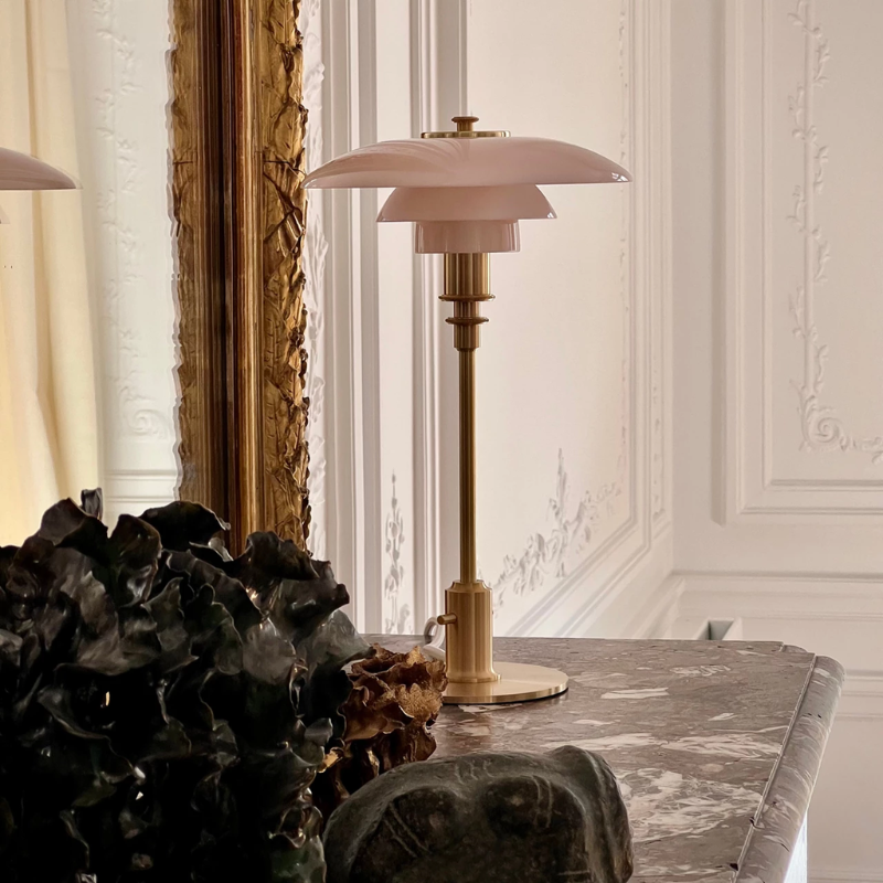 The PH 2/1 Pale Rose Brass Table Lamp from Louis Poulsen in a home office.