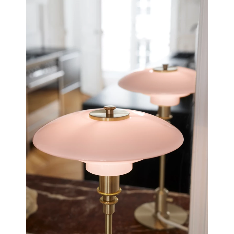 The PH 2/1 Pale Rose Brass Table Lamp from Louis Poulsen in a lounge.