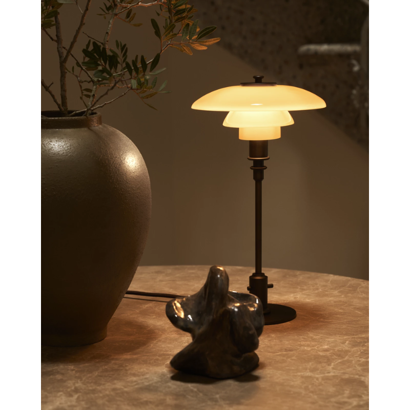 The PH 2/1 Dusty Terracotta Table Lamp from Louis Poulsen in a living room.