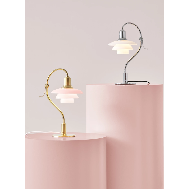 The PH 2/2 Question Mark Chrome Table Lamp from Louis Poulsen in a photograph of the Question Mark collection, alongside the Pale Rose option.