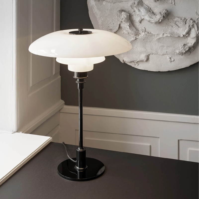 The PH 3½-2½ Glass Table Lamp from Louis Poulsen in a home office.