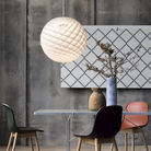 The Patera Pendant from Louis Poulsen in a dining room.