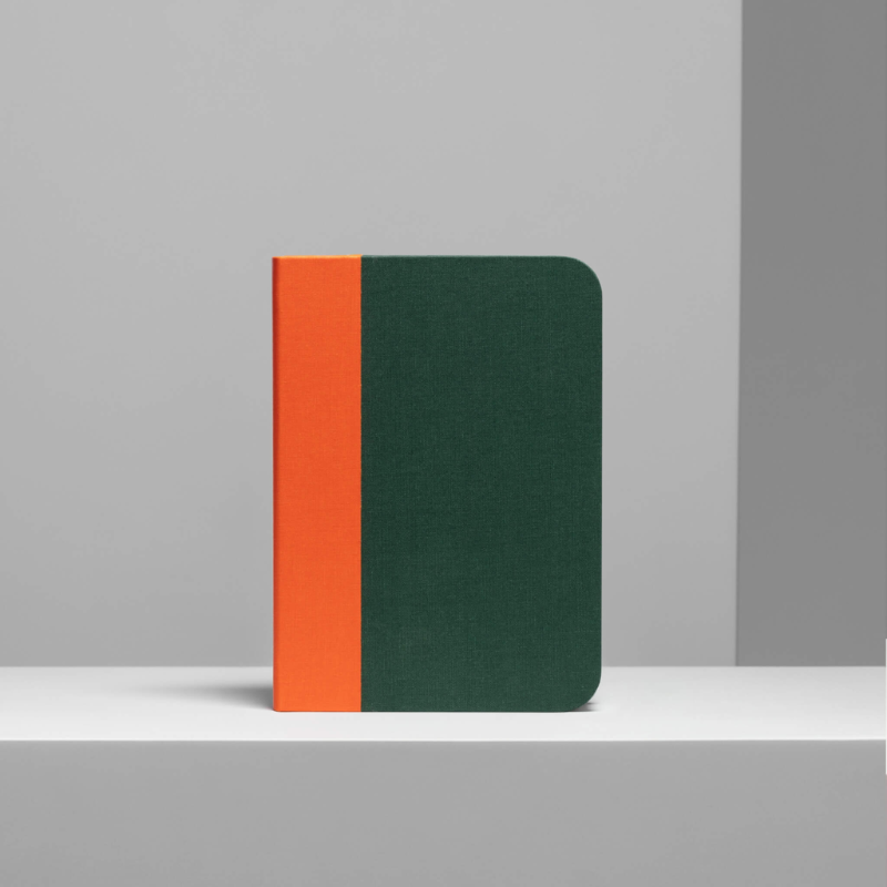 The Lito Classic from Lumio in green and orange within a photobooth studio.