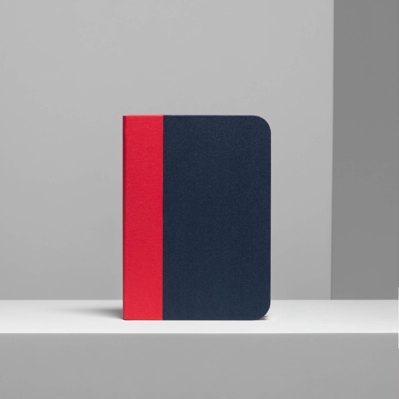 The Lito Classic from Lumio in red and navy blue within a studio.