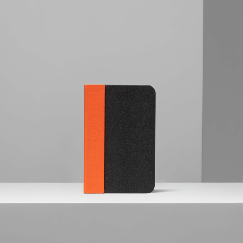 The Lito Mini from Lumio in orange and black in a lifestyle shot.