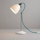 The Hector Bibendum Table Light from Original BTC in turquoise in a home.