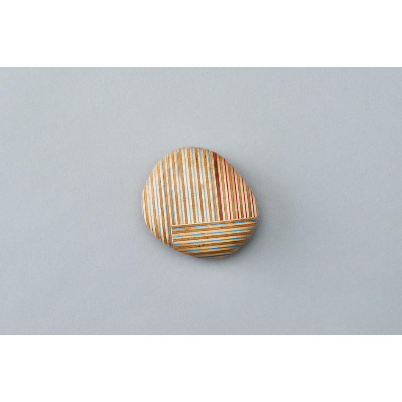 The Koishi Paperweight from Plywood Laboratory square shape in a studio.