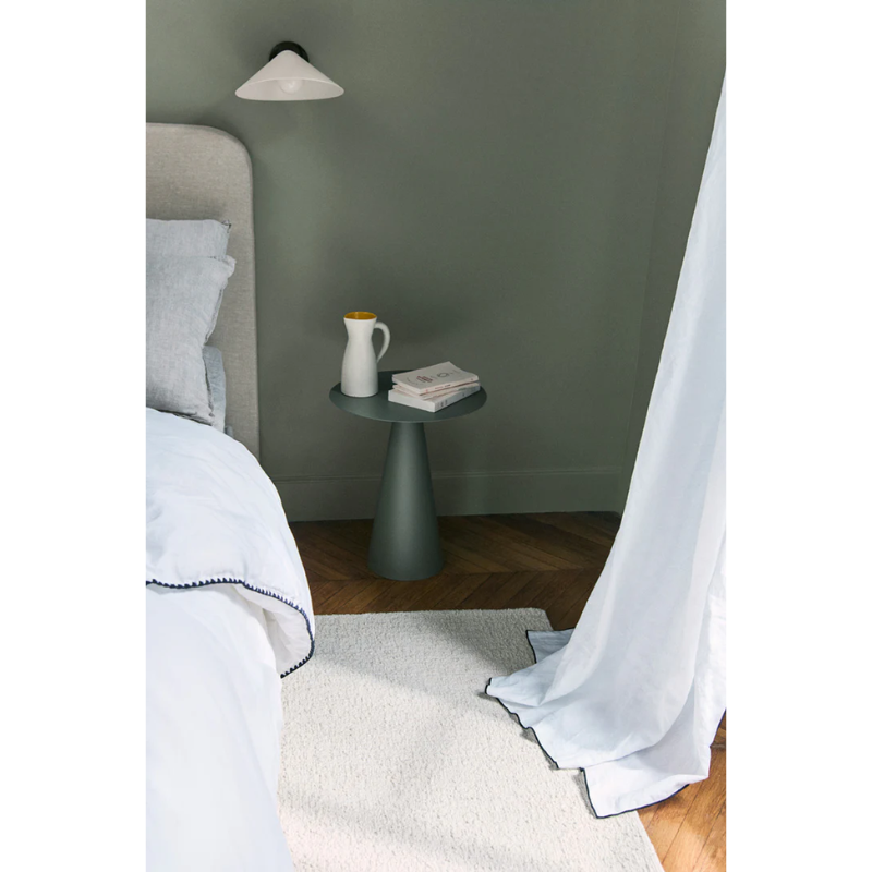 The Astrakan Neige Wool Rug from Toulemonde Bochart in a bedside lifestyle.