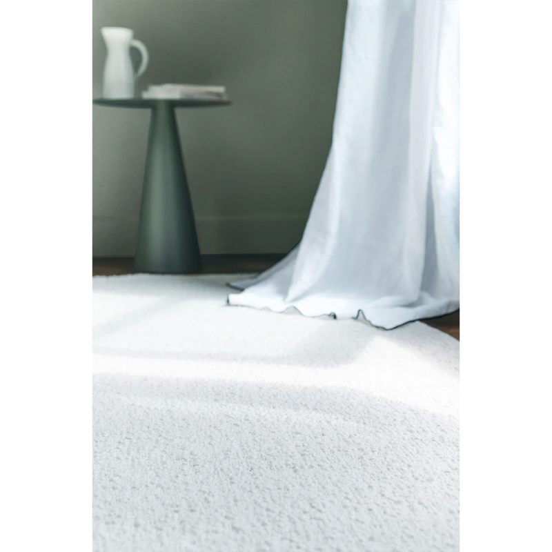 The Astrakan Neige Wool Rug from Toulemonde Bochart in focus.