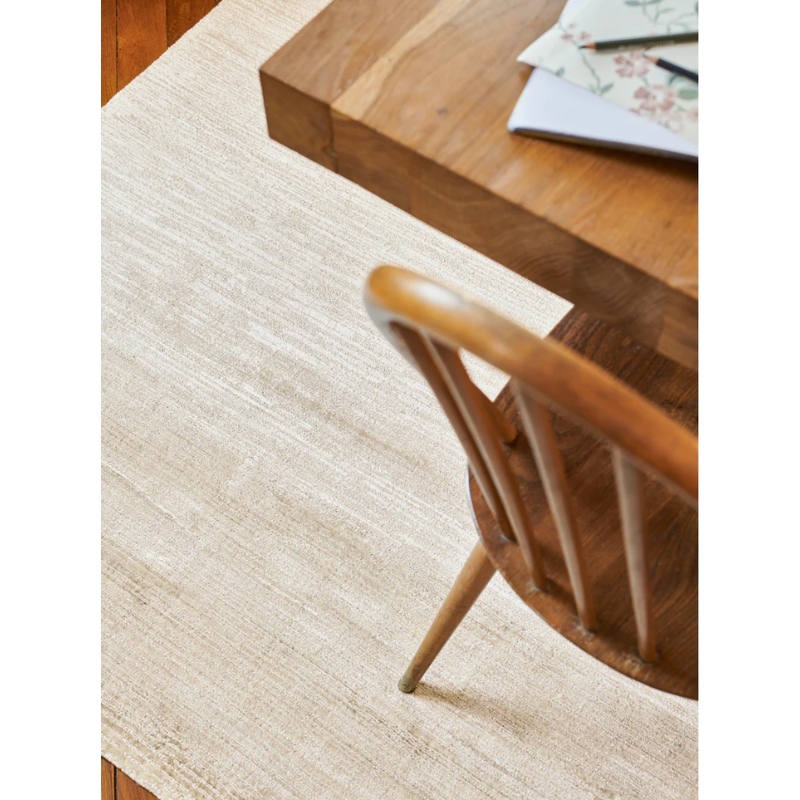 The Glam Banana Fiber Rug from Toulemonde Bochart in a kitchen and dining setting.