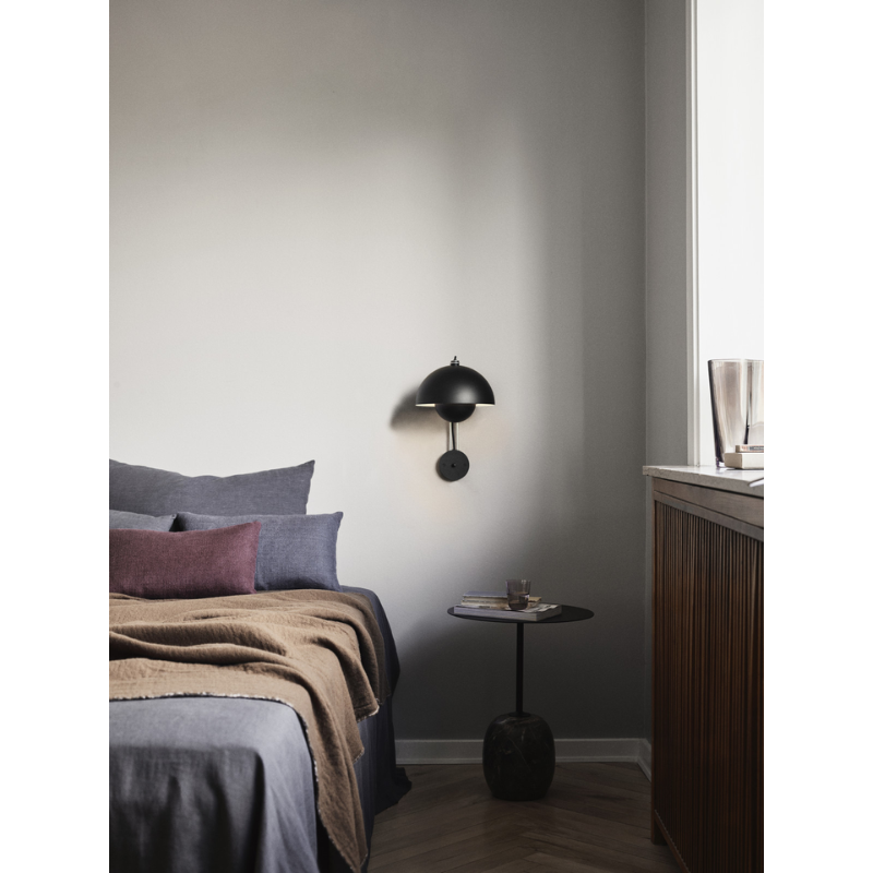 The Flowerpot VP8 Wall Sconce from &Tradition in a bedroom.