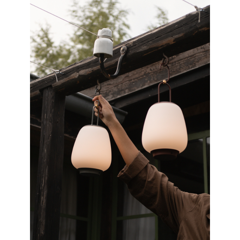 The Lucca Portable Lamp from &Tradition outdoors.