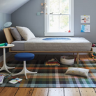 The Nelson Pedestal Stool from Herman Miller in a bedroom.