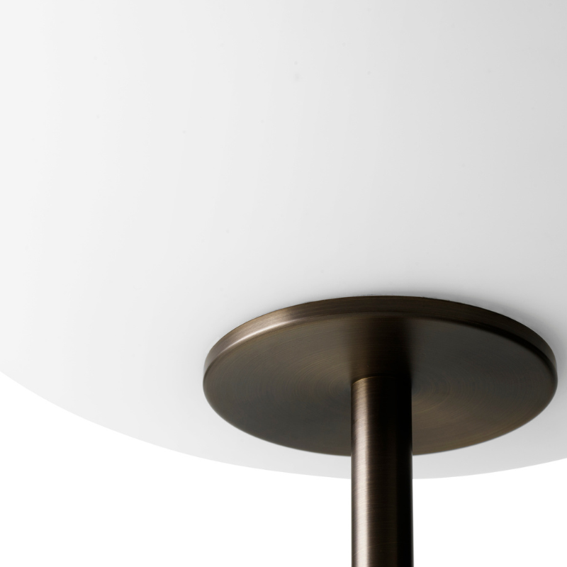 The JWDA Floor Lamp from Audo Copenhagen in travertine and brushed brass close up.