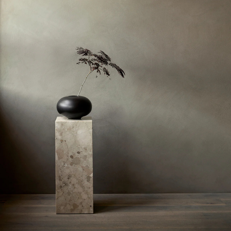 The Marble Plinth Pedestal from Audo Copenhagen in a home.