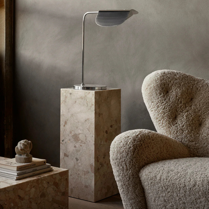 The Marble Plinth Pedestal from Audo Copenhagen in a living room.