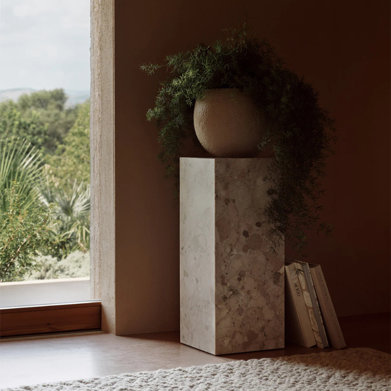 The Marble Plinth Pedestal from Audo Copenhagen in a lounge.