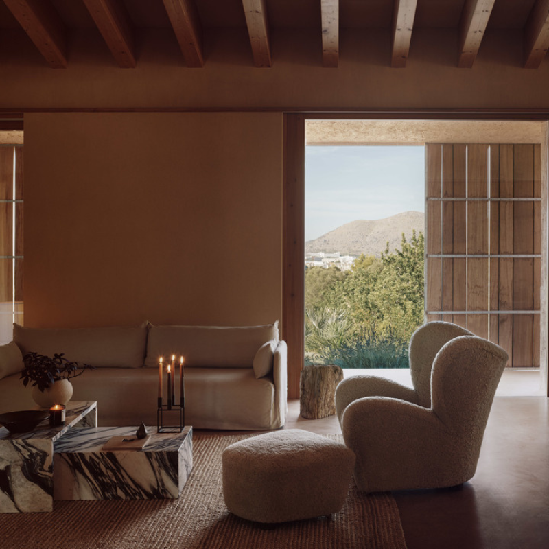 The Tired Man Sheepskin Lounge Chair from Audo Copenhagen in a family area.