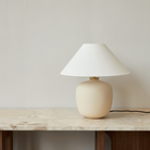 The 37 inch Torso Table Lamp by Audo Copenhagen on a marble table console.