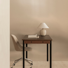 The 37 inch Torso Table Lamp by Audo Copenhagen on a desk in a home office.