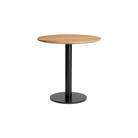 The 30 inch round Easy Dining Table from Blu Dot with a white oak  top and black base from an angle.