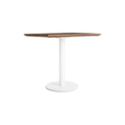 The 32 inch rectangular Easy Dining Table from Blu Dot with a walnut top and white base from an angle.