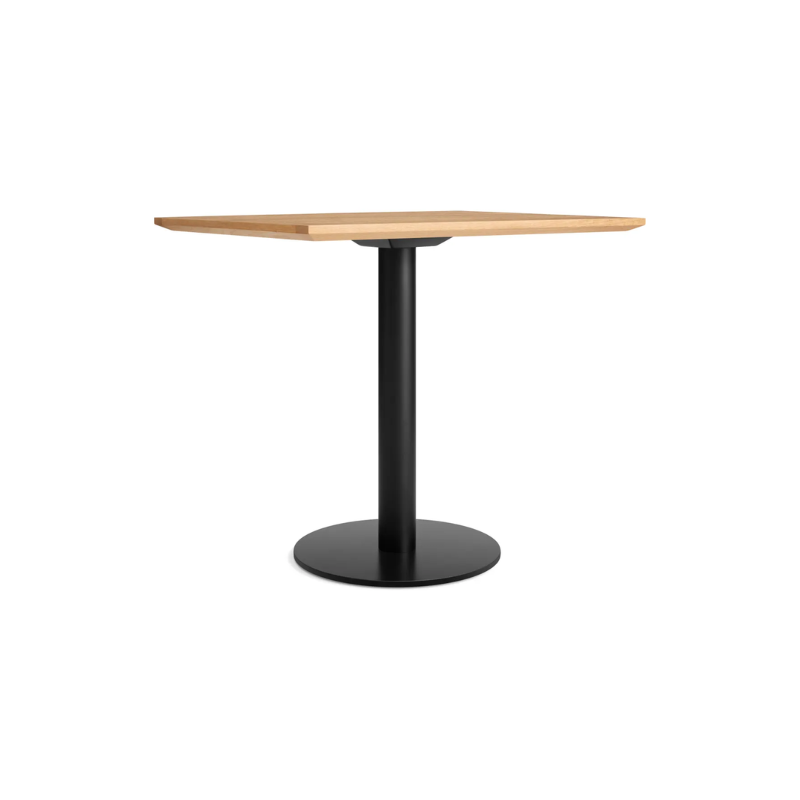 The 32 inch rectangular Easy Dining Table from Blu Dot with a white oak top and black base from an angle.