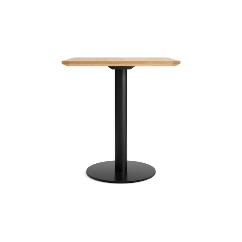 The 32 inch rectangular Easy Dining Table from Blu Dot with a white oak top and black base from the side.