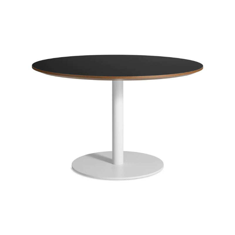 The 48 inch round Easy Dining Table from Blu Dot with a black laminate top and white base from an angle.