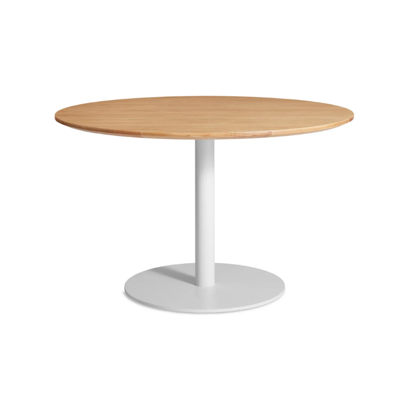 The 48 inch round Easy Dining Table from Blu Dot with a white oak top and white base from an angle.