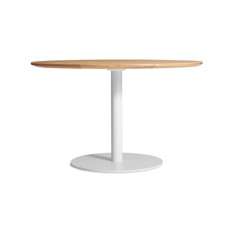 The 48 inch round Easy Dining Table from Blu Dot with a white oak top and white base.