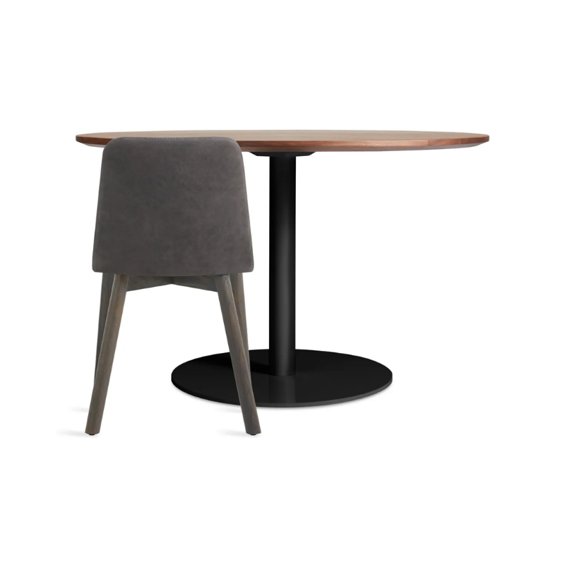 The 48 inch round Easy Dining Table from Blu Dot with a chair.